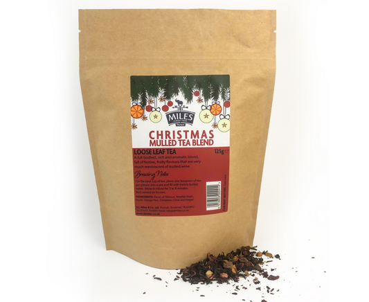 Kraft paper bag of Christmas mulled tea blend with a label on a white background