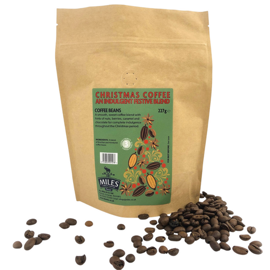 Kraft paper bag of Christmas coffee with coffee beans on a white background