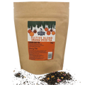 A stand-up kraft paper pouch of Miles  'Festive Blend Orange Spiced Tea' with loose tea scattered at the base on a white background.