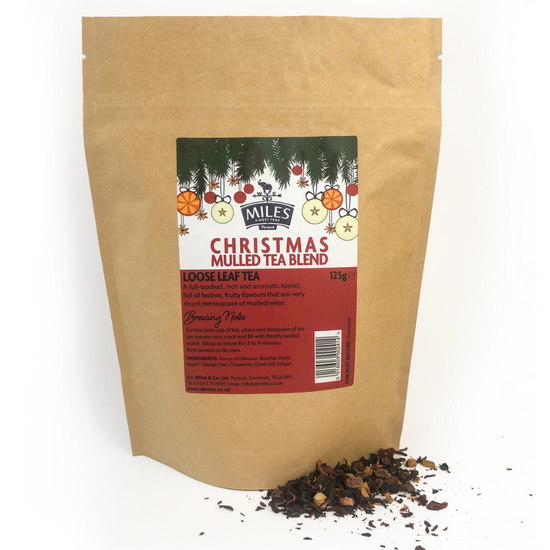 Kraft paper bag of Christmas mulled tea blend with a label on a white background