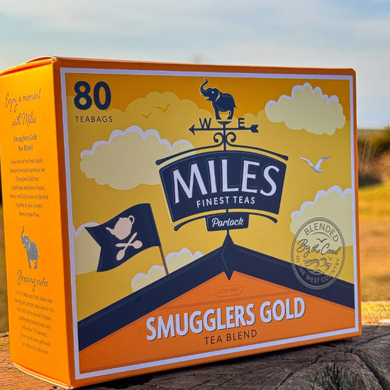 Box of Miles Finest Teas Smugglers Gold tea blend with a scenic background