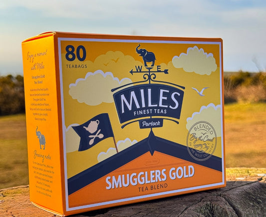Box of Miles Finest Teas Smugglers Gold tea blend with a scenic background