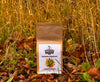 Miles Autumn Equinox loose leaf tea package in a natural setting with grass and leaves.