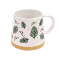 A white ceramic mug with a speckled finish, decorated with green pine leaves and small red berries, featuring a natural tan clay base and a white handle.