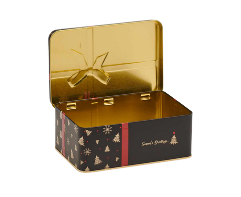 An open rectangular metal tin with a shiny gold interior and lid, featuring a black exterior decorated with gold Christmas tree and snowflake motifs, a red vertical stripe, and the words 'Seasons Greetings' in gold script.