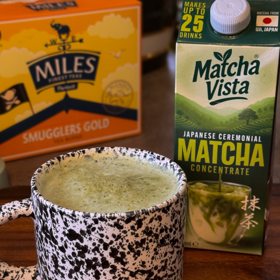 Matcha green tea concentrate box with a mug of matcha and Miles Smugglers Gold tea box.