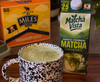 Matcha green tea concentrate box with a mug of matcha and Miles Smugglers Gold tea box.