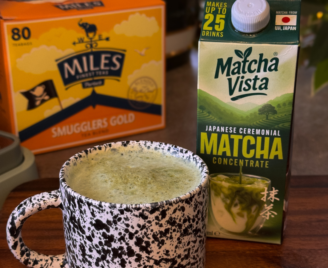 Matcha green tea concentrate box with a mug of matcha and Miles Smugglers Gold tea box.