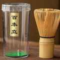 Clear container with a bamboo whisk on a brown surface
